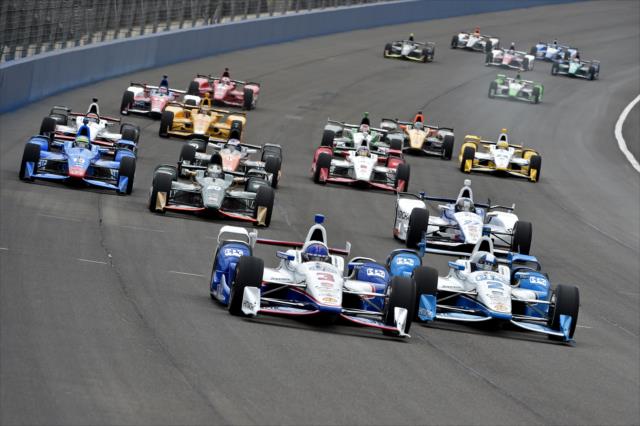 Helio Castroneves and Juan Pablo Montoya go wheel-to-wheel leading the field into Turn 1 during the MAVTV 500 at Auto Club Speedway -- Photo by: Chris Owens