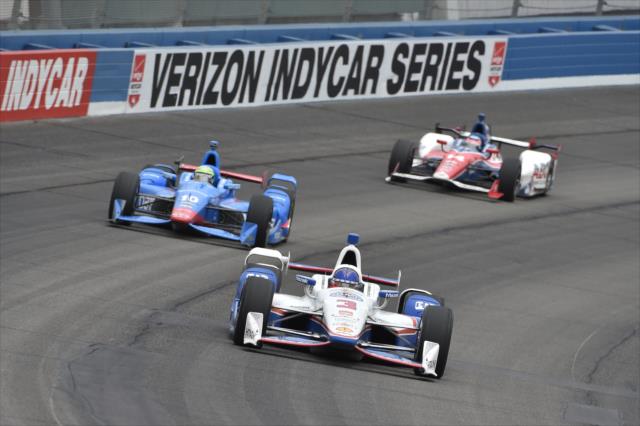 Helio Castroneves leads Tony Kanaan and Takuma Sato into Turn 2 during the MAVTV 500 at Auto Club Speedway -- Photo by: Chris Owens