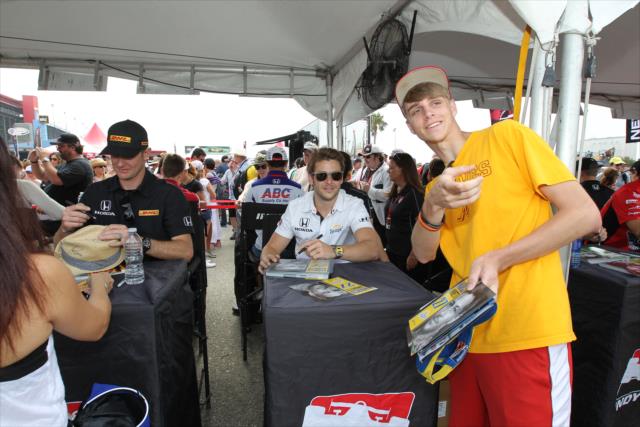 Marco Andretti poses for a photo during the autograph session in the INDYCAR Fan Village at Auto Club Speedway -- Photo by: Richard Dowdy