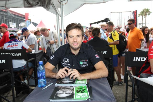 Carlos Munoz pauses for a photo during the autograph session in the INDYCAR Fan Village at Auto Club Speedway -- Photo by: Richard Dowdy