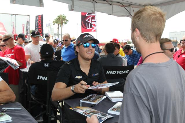 Stefano Coletti signs an autograph during the autograph session in the INDYCAR Fan Village at Auto Club Speedway -- Photo by: Richard Dowdy