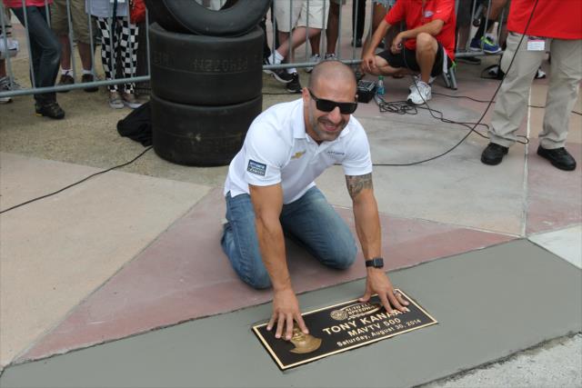 Tony Kanaan places his Walk-Of-Fame plaque into the concrete at Auto Club Speedway as the winner of the 2014 MAVTV 500 -- Photo by: Richard Dowdy