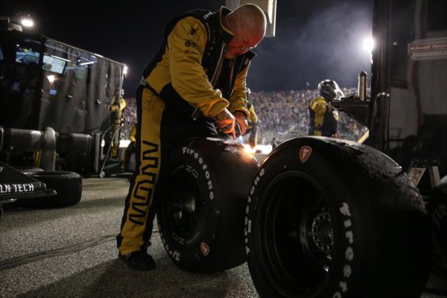 A Schmidt Peterson Motorsports crewman examines Firestone Firehawk tires on pit lane during the Bommarito Automotive Group 500 at Gateway Motorsports Park -- Photo by: Chris Jones