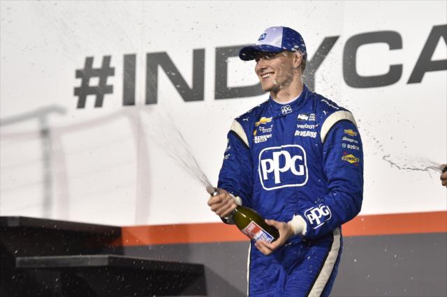 Josef Newgarden sprays the champagne on Victory Stage after winning the Bommarito Automotive Group 500 at Gateway Motorsports Park -- Photo by: Chris Owens