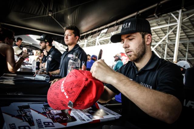Ed Jones signs an autograph hat during the autograph session in the INDYCAR Fan Village at Gateway Motorsports Park -- Photo by: Shawn Gritzmacher