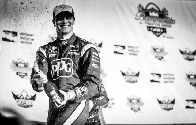 Josef Newgarden sprays the champagne on Victory Stage after winning the Bommarito Automotive Group 500 at Gateway Motorsports Park -- Photo by: Shawn Gritzmacher