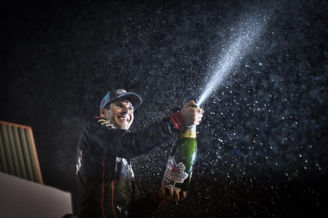 Will Power sprays the champagne on stage after winning the Bommarito Automotive Group 500 at Gateway Motorsports Park -- Photo by: Chris Owens