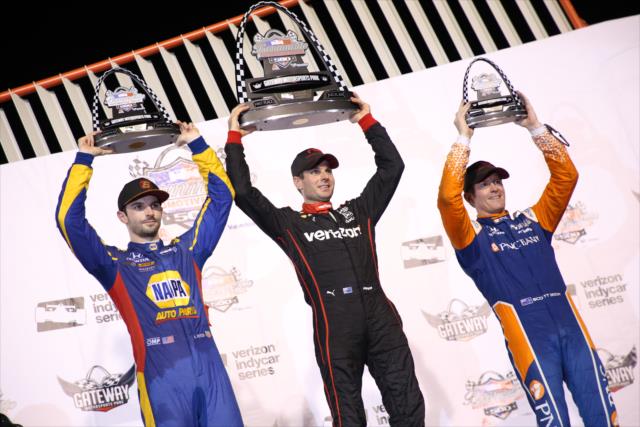 The podium of Will Power, Alexander Rossi, and Scott Dixon hoist their trophies on stage following the Bommarito Automotive Group 500 at Gateway Motorsports Park -- Photo by: Matt Fraver