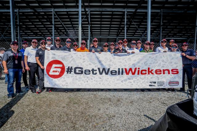 The Verizon IndyCar Series drivers with the #GetWellWickens banner during the autograph session at Gateway Motorsports Park -- Photo by: Shawn Gritzmacher