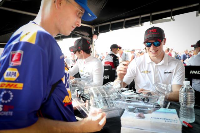 Josef Newgarden signs an autograph for a fan during the autograph session at Gateway Motorsports Park -- Photo by: Shawn Gritzmacher