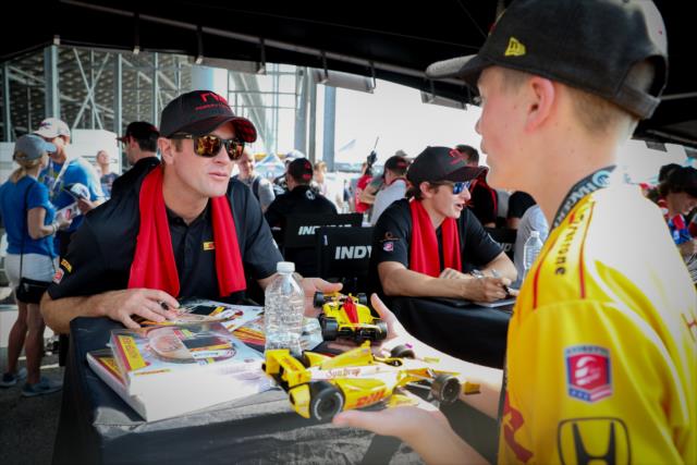 Ryan Hunter-Reay signs a pair of die-cast cars during the autograph session at Gateway Motorsports Park -- Photo by: Shawn Gritzmacher