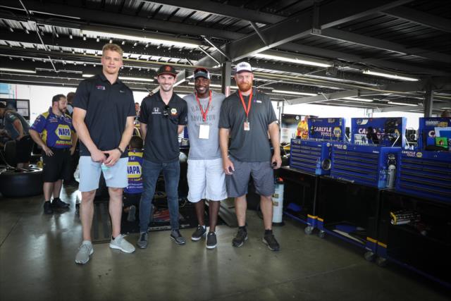 Alexander Rossi with St. Louis Blues player Colton Parayko and former St. Louis Rams players Will Witherspoon and Andy McCollum in the Andretti Autosport garage at Gateway Motorsports Park -- Photo by: Shawn Gritzmacher