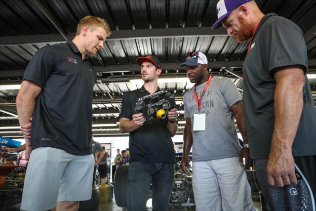 Alexander Rossi with St. Louis Blues player Colton Parayko and former St. Louis Rams players Will Witherspoon and Andy McCollum in the Andretti Autosport garage at Gateway Motorsports Park -- Photo by: Shawn Gritzmacher