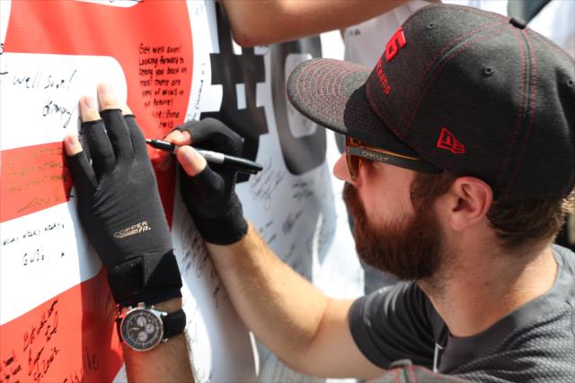 James Hinchcliffe signs the #GetWellWickens banner for Robert Wickens during the autograph session at Gateway Motorsports Park -- Photo by: Shawn Gritzmacher