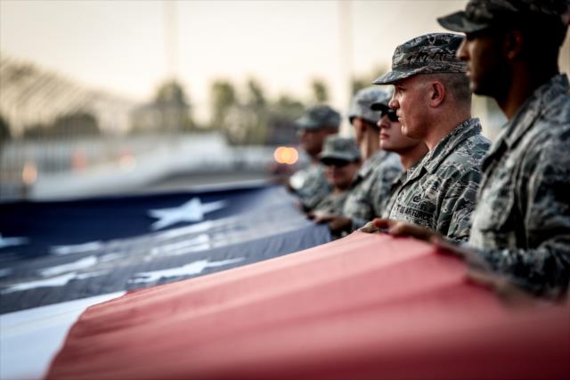 Members of the military with the American Flag during pre-race festivities for the Bommarito Automotive Group 500 at Gateway Motorsports Park -- Photo by: Shawn Gritzmacher
