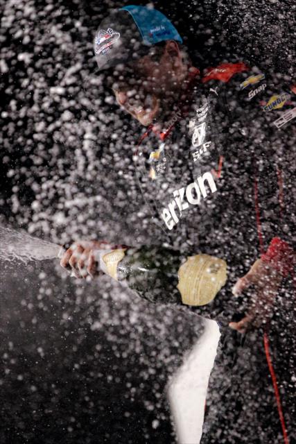 Will Power sprays the champagne on stage after winning the Bommarito Automotive Group 500 at Gateway Motorsports Park -- Photo by: Shawn Gritzmacher