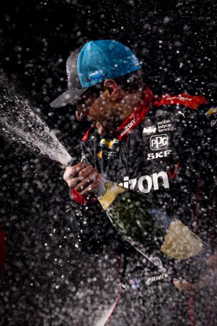 Will Power sprays the champagne on stage after winning the Bommarito Automotive Group 500 at Gateway Motorsports Park -- Photo by: Shawn Gritzmacher