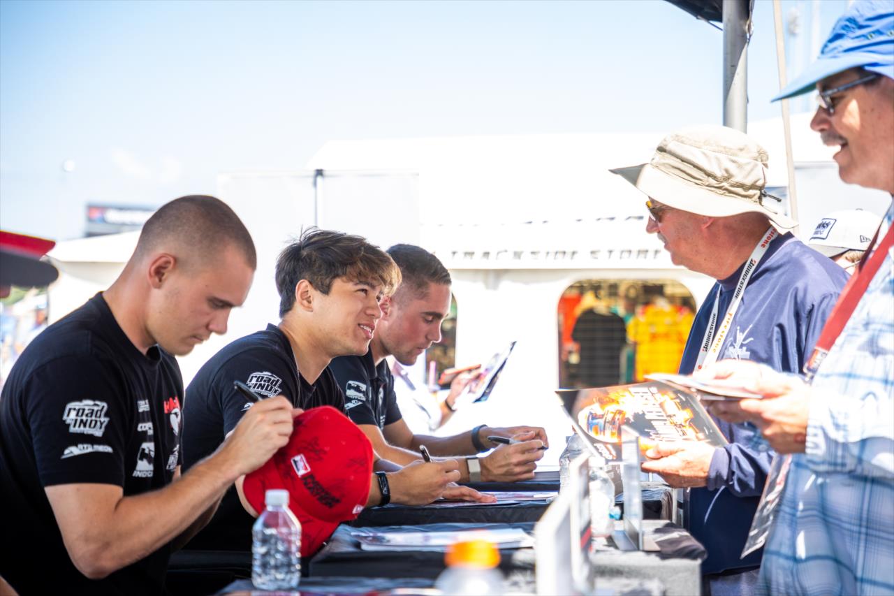 Linus Lundqvist and Danial Frost with fans - Indy Lights at World Wide Technology Raceway - By: Sean Birkle -- Photo by: Sean Birkle