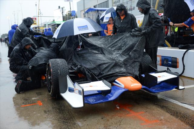 The Novo Nordisk Chip Ganassi team cover up Charlie Kimball's car during the rain delay -- Photo by: Chris Owens