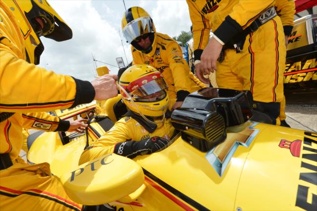 Helio Castroneves climbs into his car before Race 2. -- Photo by: Chris Owens