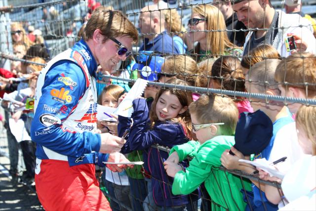 Conor Daly signs autographs for fans -- Photo by: Chris Jones