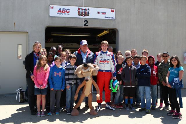 Conor Daly and AJ Foyt pose with young fans -- Photo by: Chris Jones