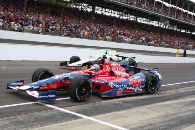 Marco Andretti and Ed Carpenter race off pit lane -- Photo by: Chris Jones