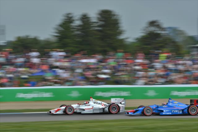 Helio Castroneves and Tony Kanaan go nose-to-tail exiting Turn 2 during the Angie's List Grand Prix of Indianapolis at the Indianapolis Motor Speedway -- Photo by: Chris Owens
