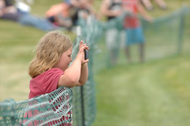 A young fan snaps a photograph during the Angie's List Grand Prix of Indianapolis at the Indianapolis Motor Speedway -- Photo by: Dana Garrett
