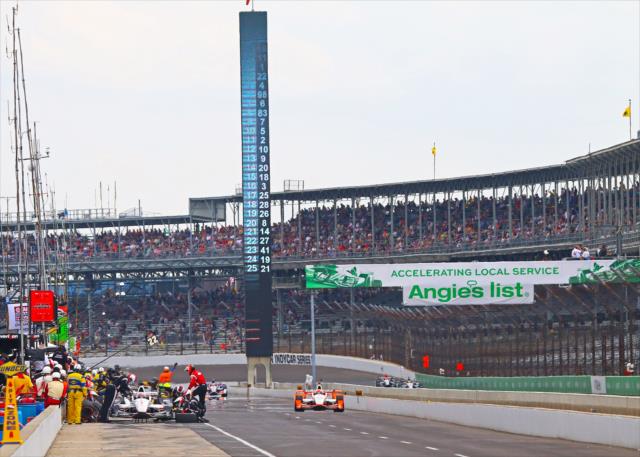 Pit lane comes to life for early stops during the Angie's List Grand Prix of Indianapolis at the Indianapolis Motor Speedway -- Photo by: Mike Harding