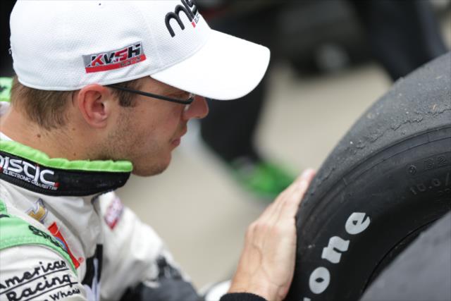 Sebastien Bourdais inspects his tires prior to the Angie's List Grand Prix of Indianapolis at the Indianapolis Motor Speedway -- Photo by: Shawn Gritzmacher