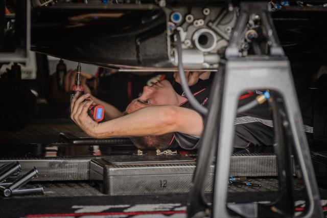 Mechanic works on a car in the garages at IMS -- Photo by: Forrest Mellott