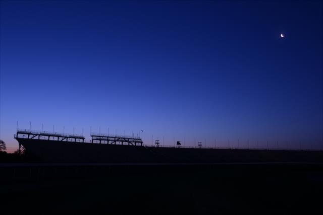 The sun sets over Turn 4 at the Indianapolis Motor Speedway -- Photo by: Walter Kuhn