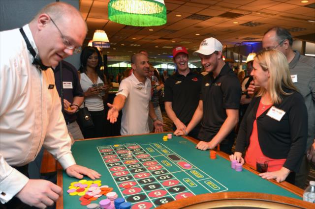 Tony Kanaan, Scott Dixon, and Sage Karam take in some roulette at the annual casino night at the Indianapolis Motor Speedway -- Photo by: Chris Owens