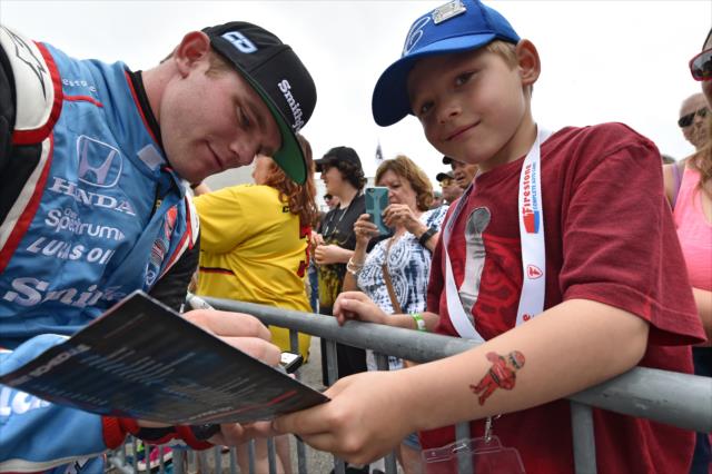 Young race fans gets an autograph from Conor Daly -- Photo by: John Cote