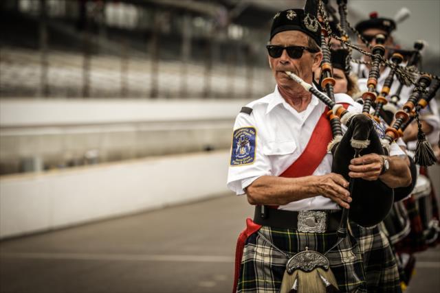 The Gordon Pipers play along pit lane prior to the final practice before qualifications for the 99th Indianapolis 500 -- Photo by: Shawn Gritzmacher
