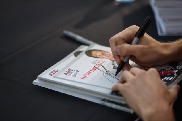 Jack Hawksworth signs an autograph during the autograph session on Legends Day at the Indianapolis Motor Speedway -- Photo by: Eric Anderson