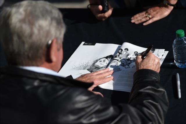 Al Unser signs a program during the autograph session on Legends Day at the Indianapolis Motor Speedway -- Photo by: Eric Anderson