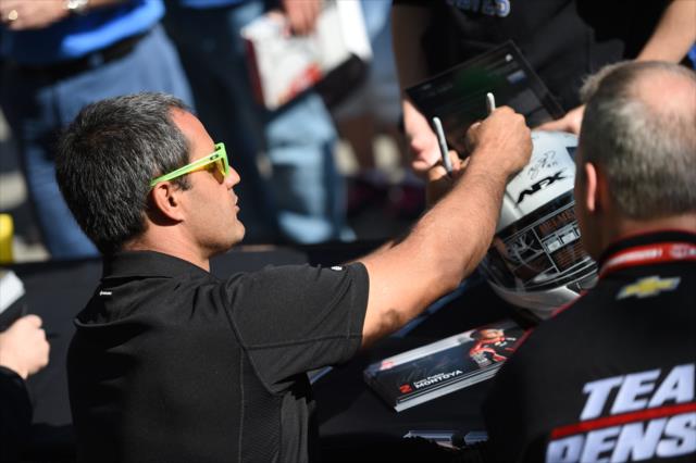 Juan Pablo Montoya signs an autograph during the autograph session on Legends Day at the Indianapolis Motor Speedway -- Photo by: Eric Anderson