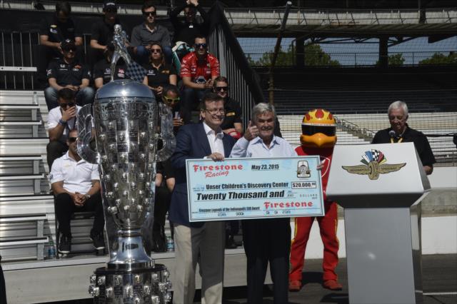 Al Unser accepts a donation from Firestone to his children's charity during the public drivers meeting at the Indianapolis Motor Speedway -- Photo by: Jim Haines