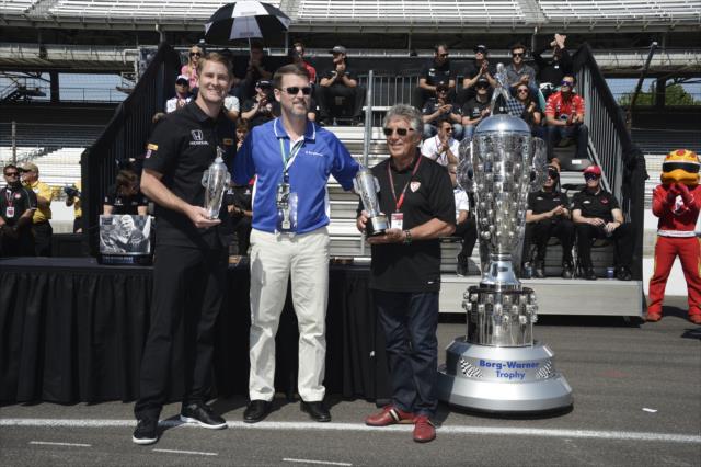 Ryan Hunter-Reay and Mario Andretti accept Baby Borg trophies during the public drivers meeting at the Indianapolis Motor Speedway -- Photo by: Jim Haines