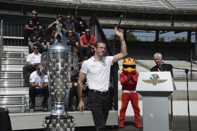 Sebastien Bourdais waives to the crowd during the public drivers meeting at the Indianapolis Motor Speedway -- Photo by: Jim Haines