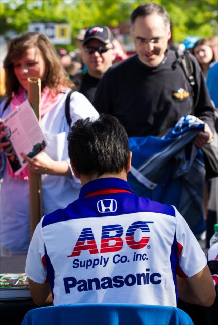 Takuma Sato signs autographs for fans during the full field autograph session at IMS -- Photo by: Jason Porter