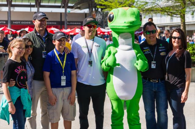 Fans stand with the Geico gecko at IMS -- Photo by: Jason Porter