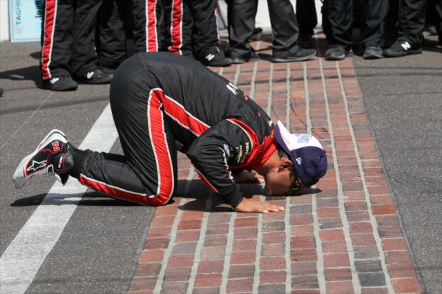 Juan Pablo Montoya kisses the bricks after winning the 99th Running of the Indianapolis 500 -- Photo by: Joe Skibinski
