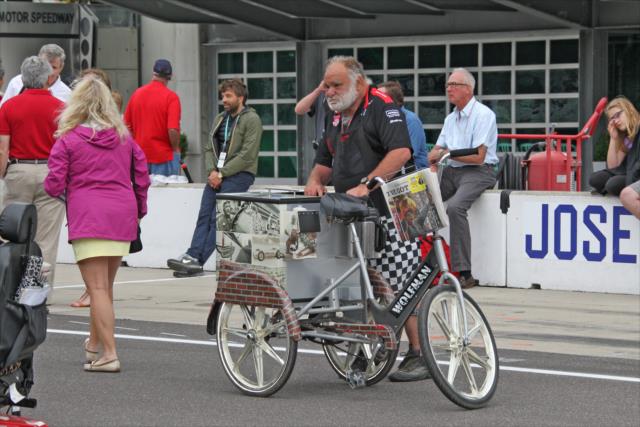 Chucky delivers paper to Juan Pablo Montoya on yard of bricks -- Photo by: Richard Dowdy