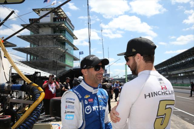 Tony Kanaan chatting with fellow IndyCar driver James Hinchcliffe. -- Photo by: Chris Jones