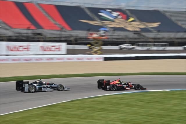 Sebastian Bourdais with Helio on his tail during qualifying for the Angie's List Grand Prix of Indianapolis. -- Photo by: John Cote