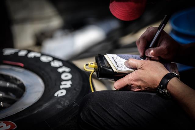Crew member checks a Firestone Firehawk tire at IMS -- Photo by: Shawn Gritzmacher
