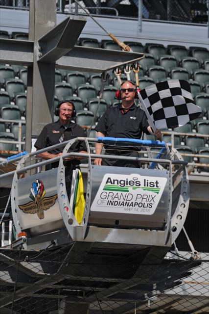 Flagman Tom Hansing throws the checkered flag to complete practice for the Angie's List Grand Prix of Indianapolis -- Photo by: Walter Kuhn